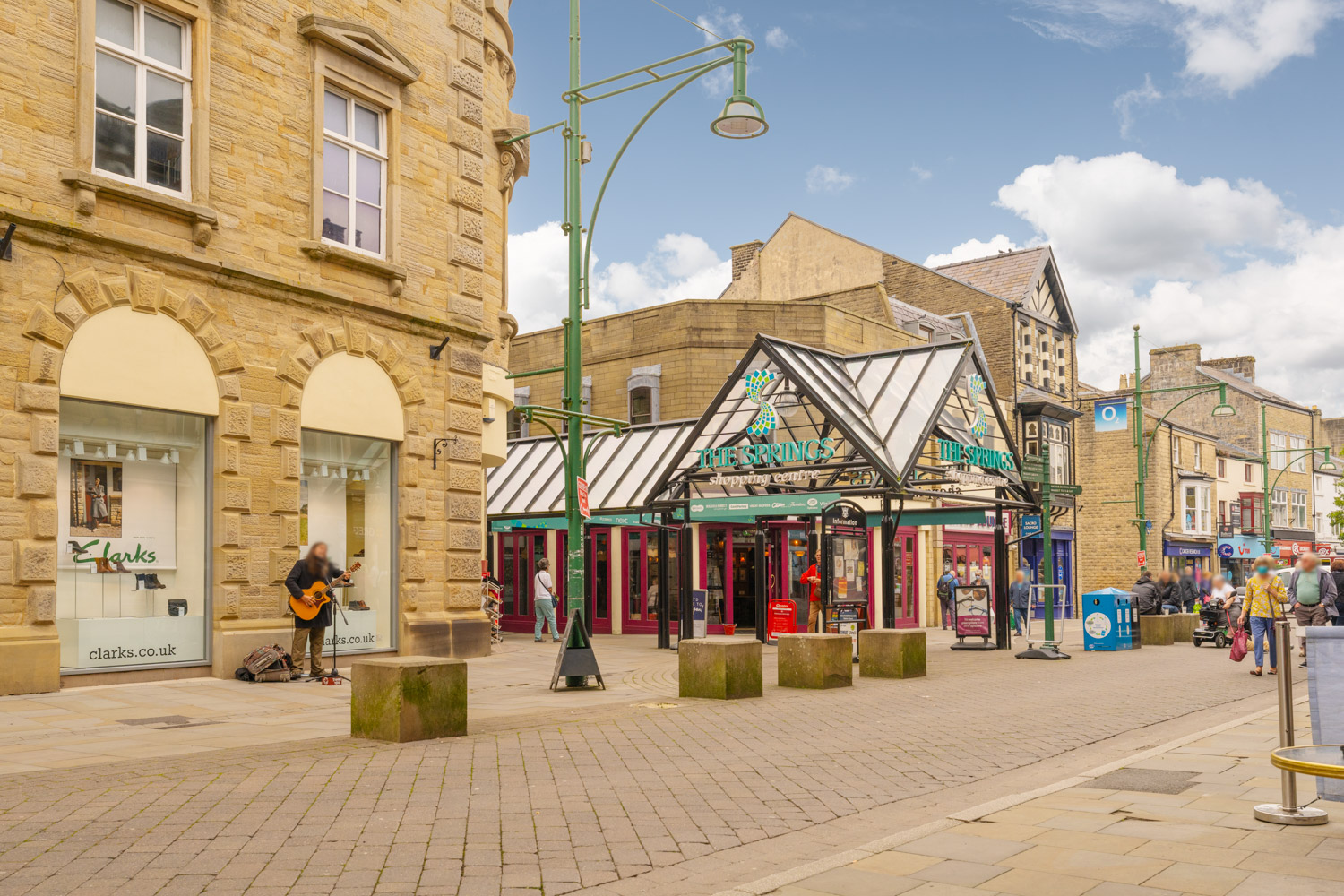 a street with buildings and people