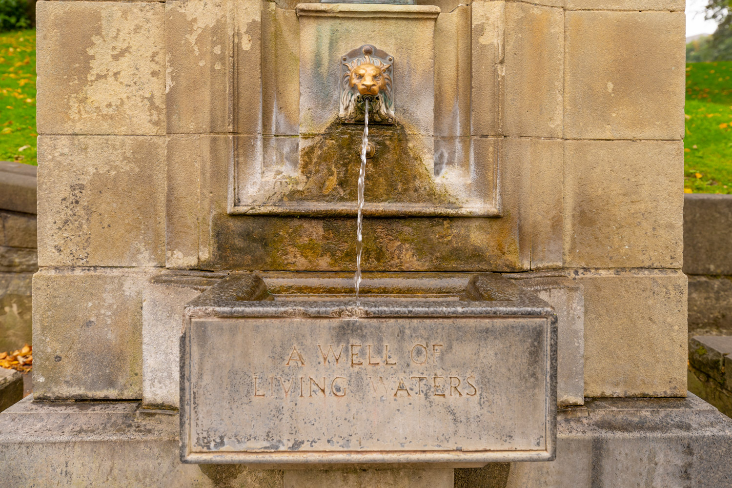 a water fountain with a stone plaque