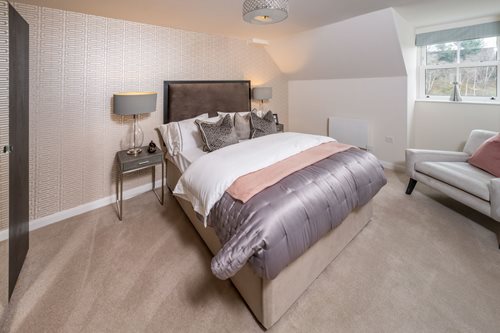 a bedroom with a bed and a couch