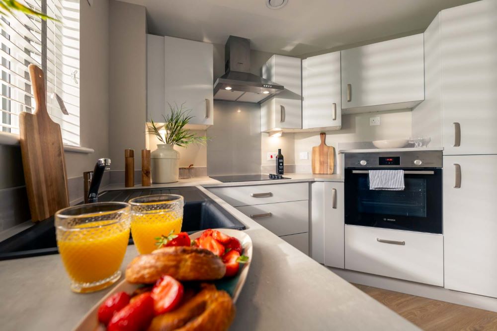 a kitchen with white cabinets and a few food items on the counter