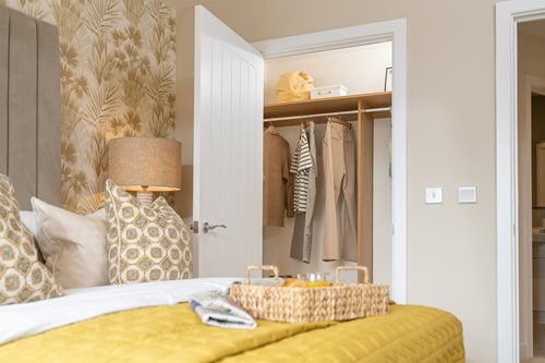 a bed with a yellow bed spread