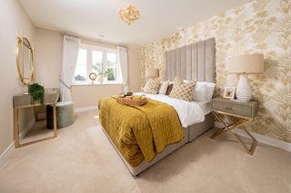 a bedroom with a bed and lamps
