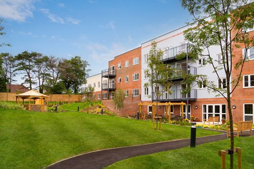 a building with a lawn and trees