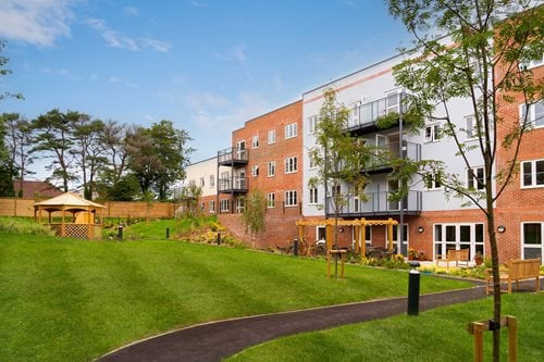 a building with a lawn and trees