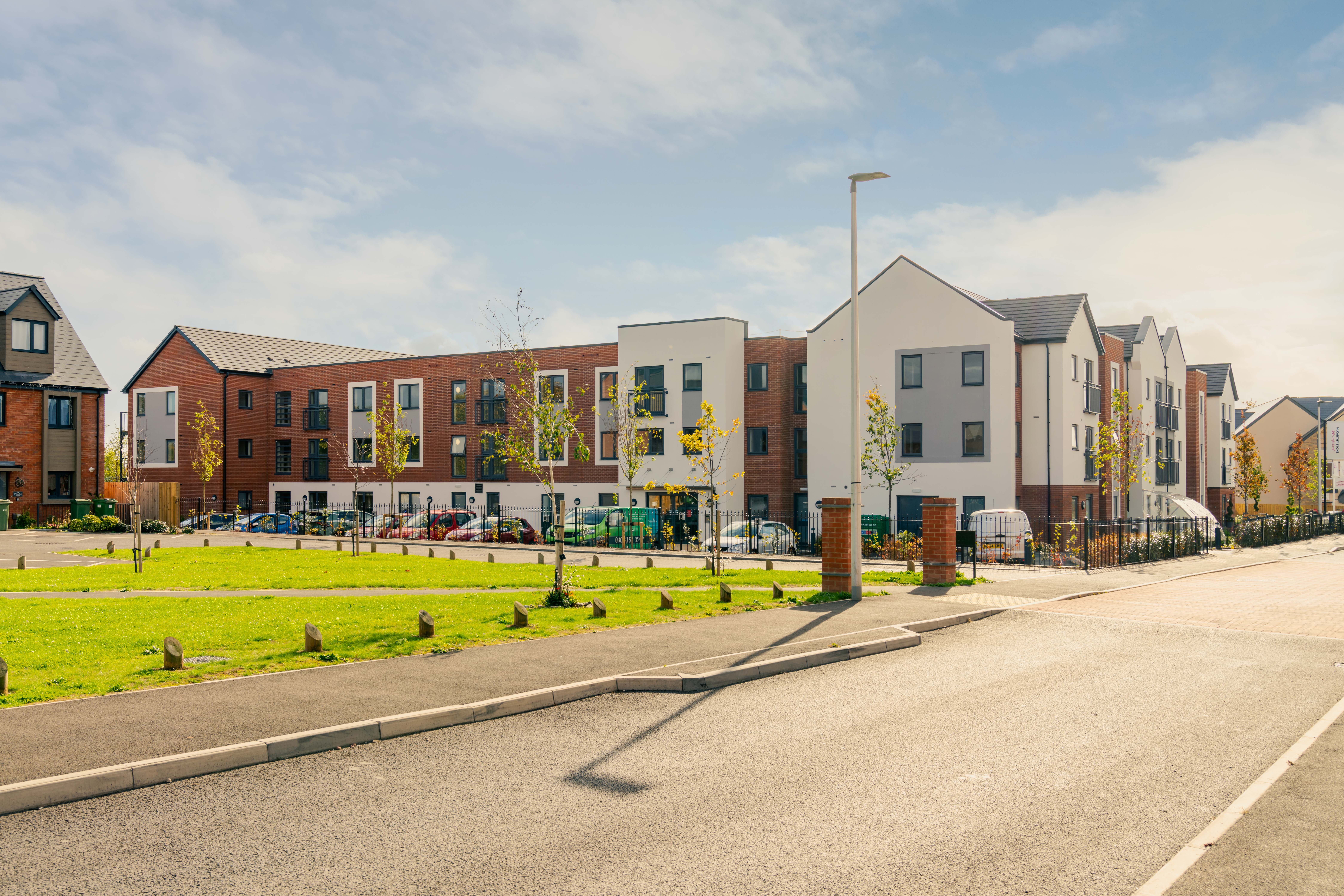 a street with buildings and a fence