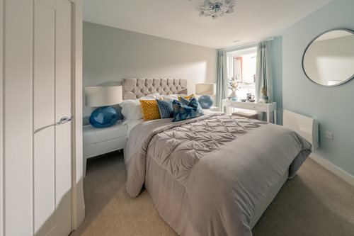 a bedroom with a bed and a mirror