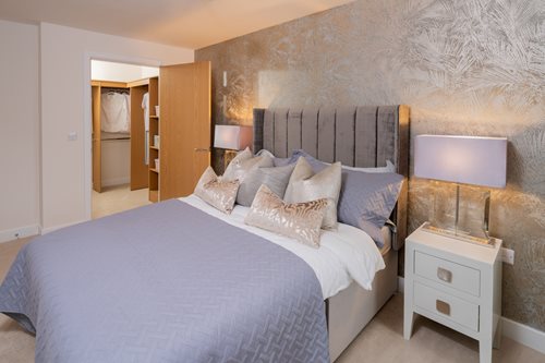 a bed with a lamp on the side