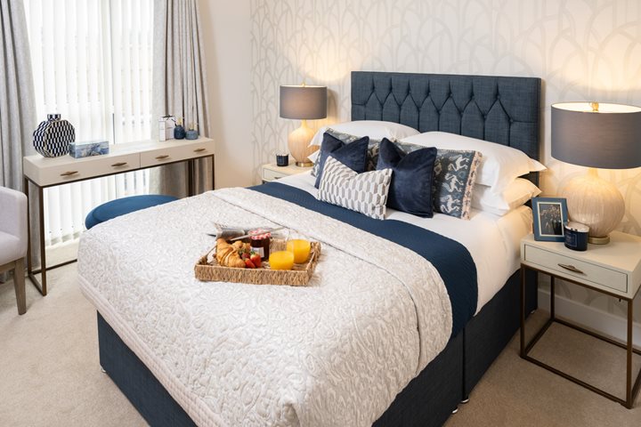 a bed with a basket of fruit on it