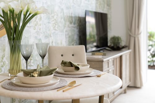 a dining table with plates and glasses