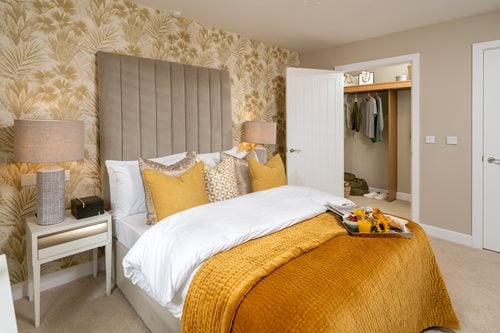 a bedroom with a bed and a lamp