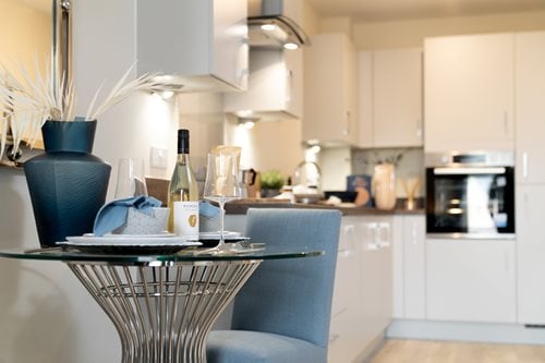 a kitchen with a table and chairs