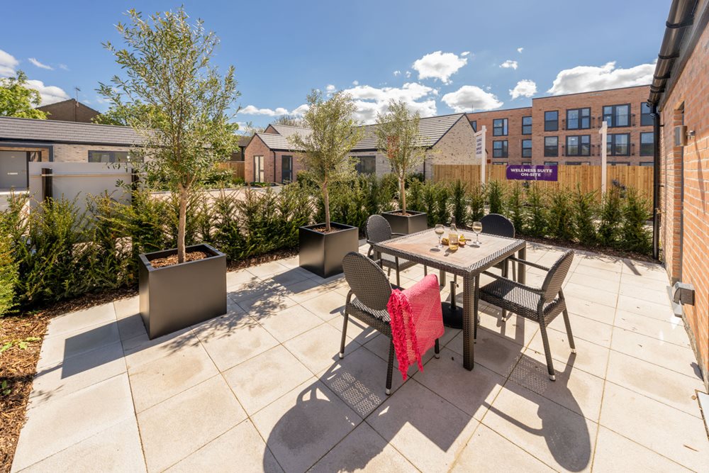 a patio with a table and chairs