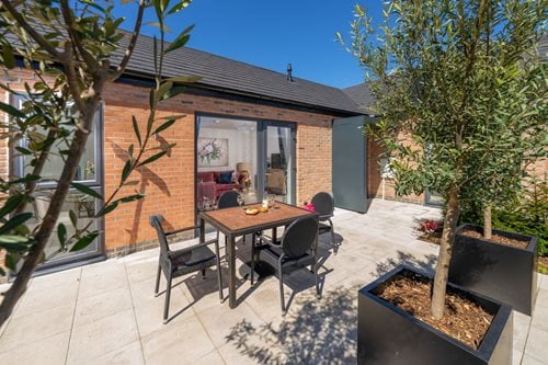 a table and chairs outside a house