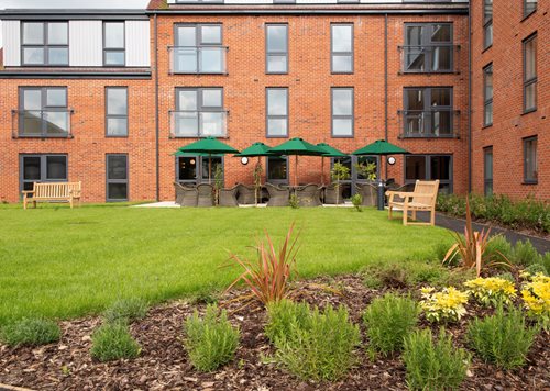 a building with benches and grass
