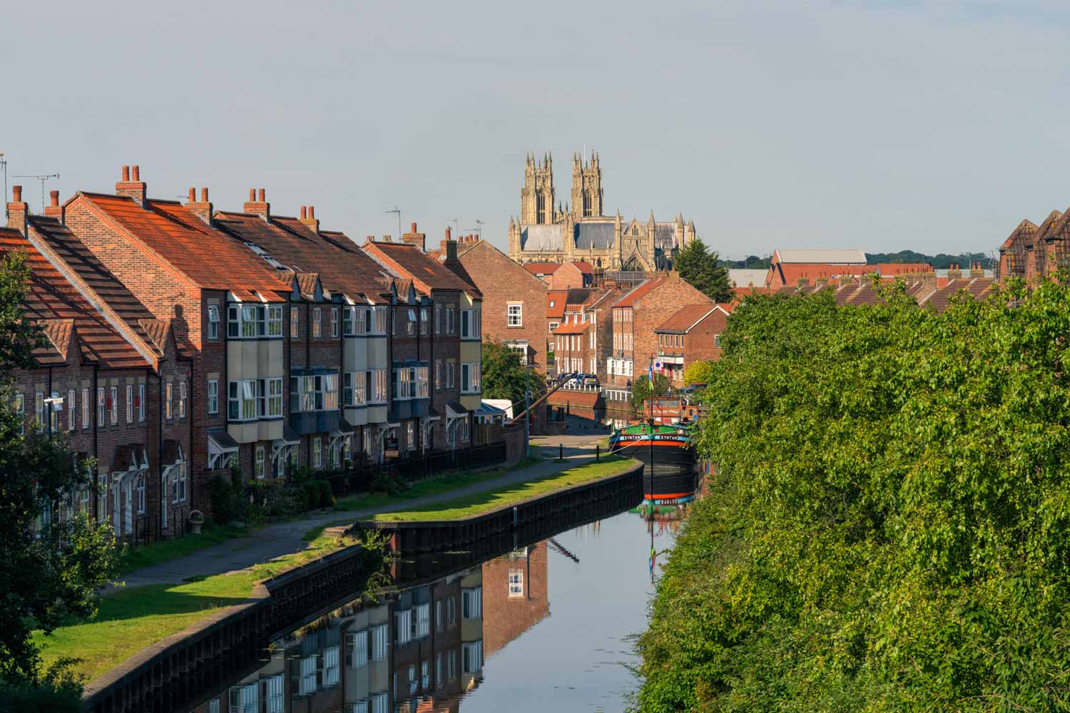 a canal with buildings and trees
