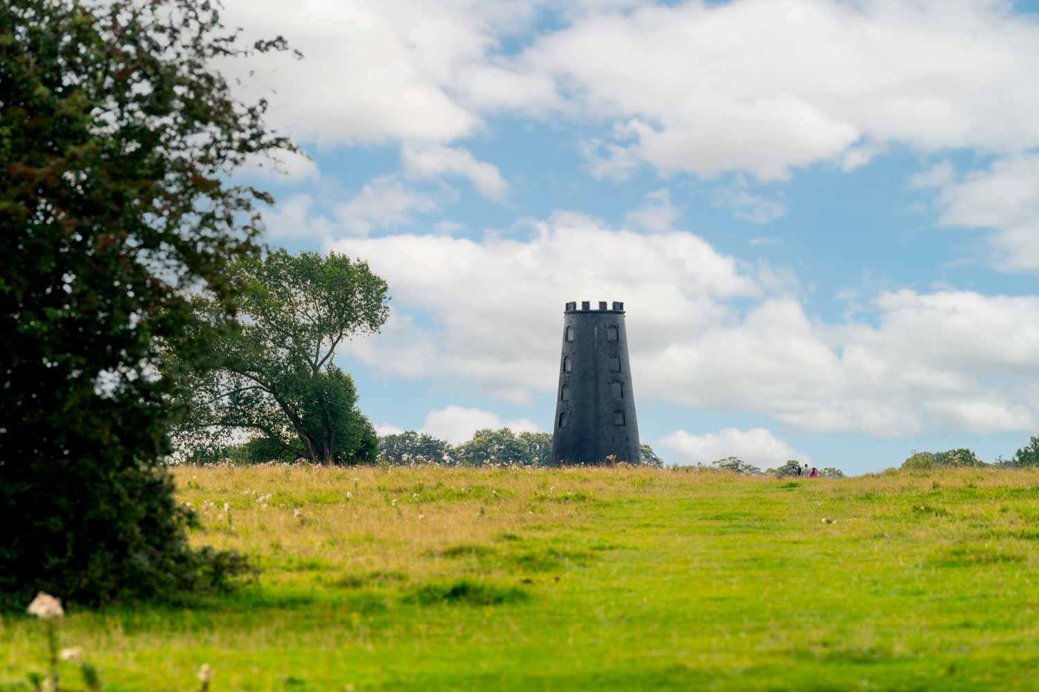 a stone tower in a field