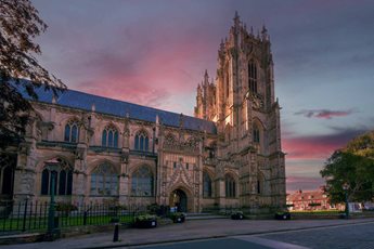 The beautiful stone exterior of Beverley Minster during a sunset.