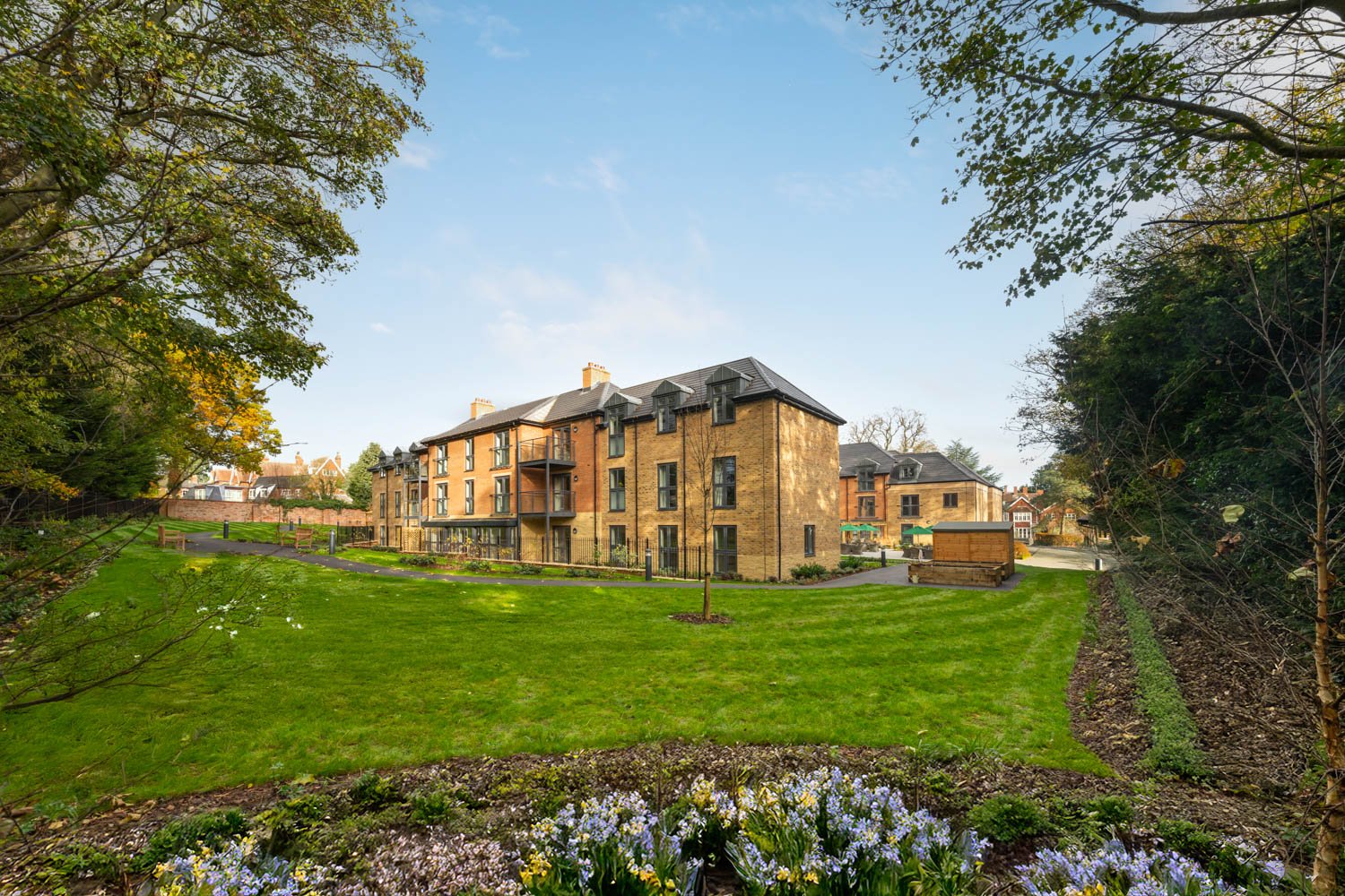 a large house with a pond in front of it