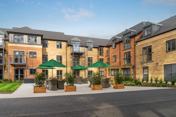 a building with a courtyard and umbrellas