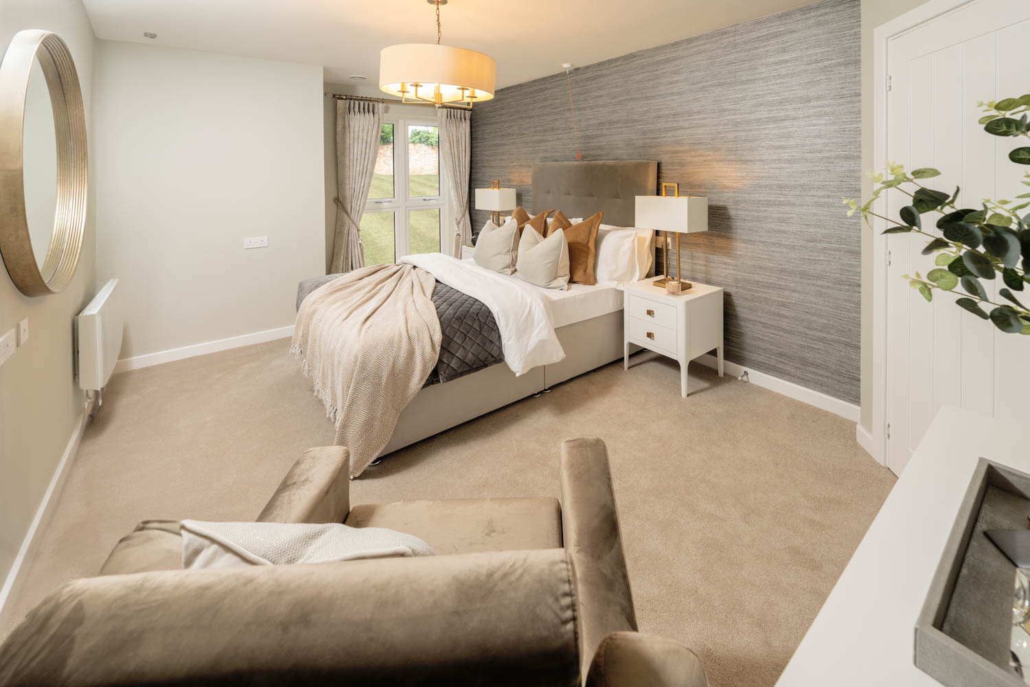 a large bedroom with a bed and couches