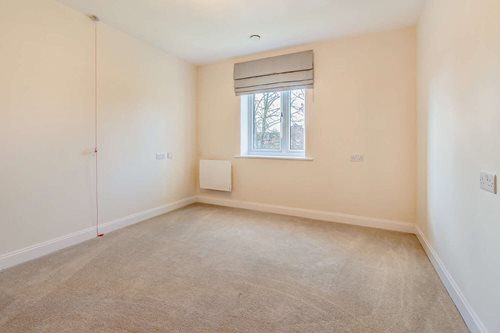 a room with a window and a carpet