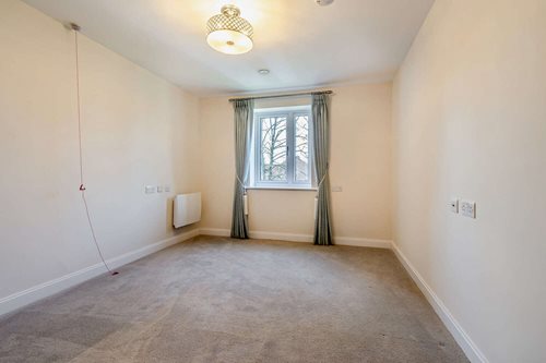 a room with a carpet and a window