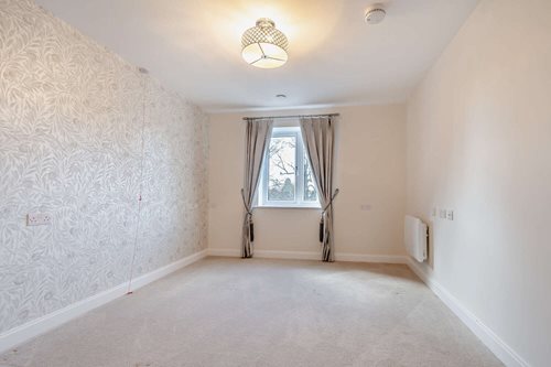 a room with a window and curtains