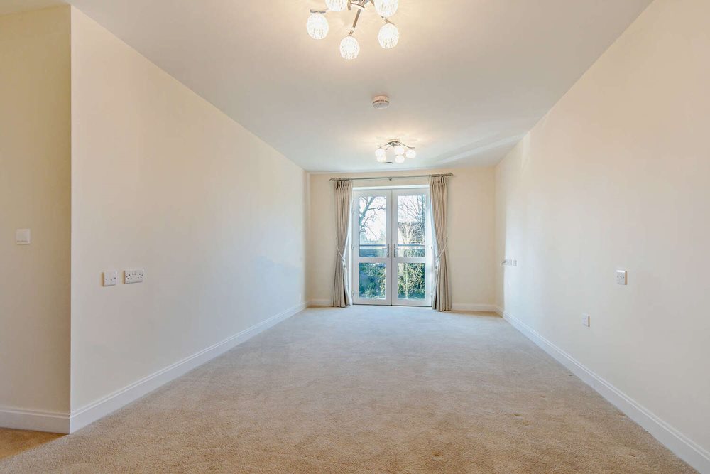 a room with a window and a carpet