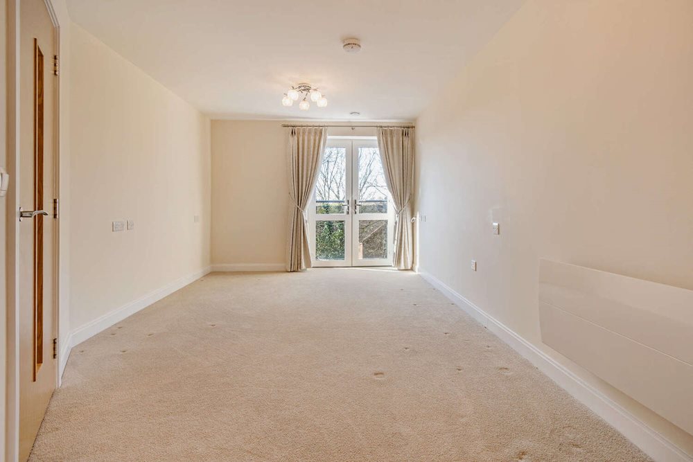 a room with a window and curtains