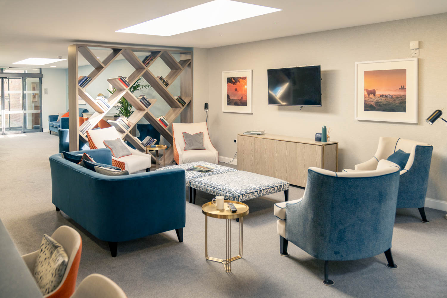 a living room with blue chairs and a table