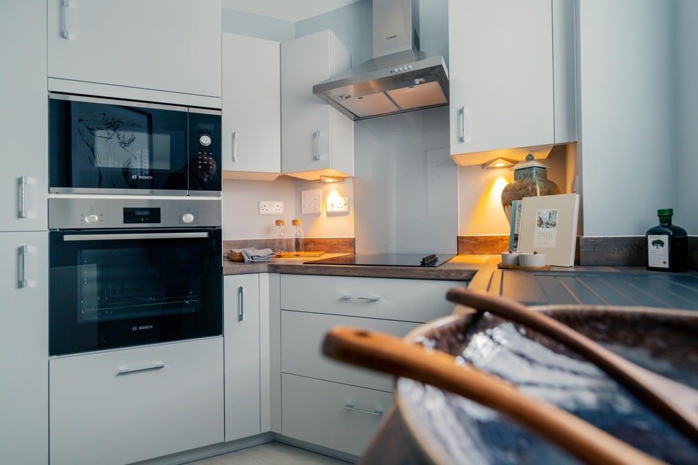 a kitchen with a microwave oven and a large oven