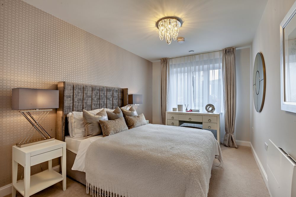 a bedroom with a bed and a lamp
