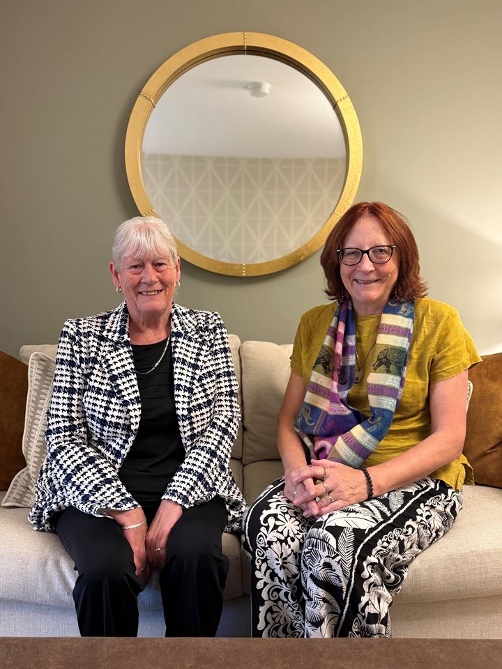 a couple of women sitting on a couch