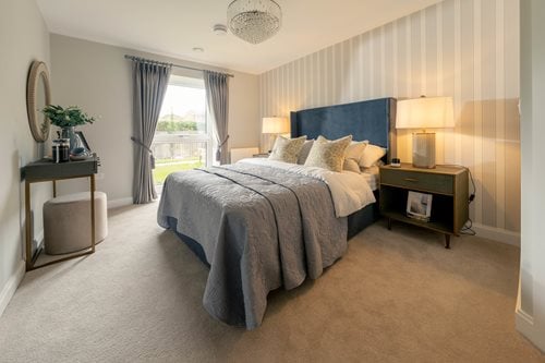 a bedroom with a bed and a tv