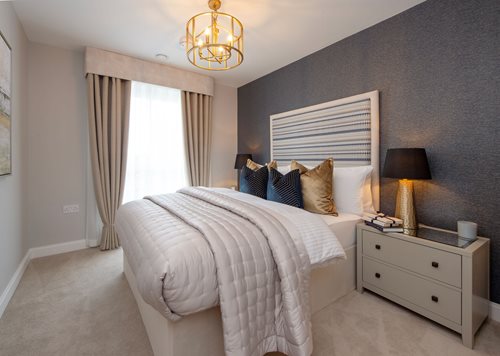 a bedroom with a bed and a lamp