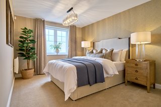 a bedroom with a bed and lamps