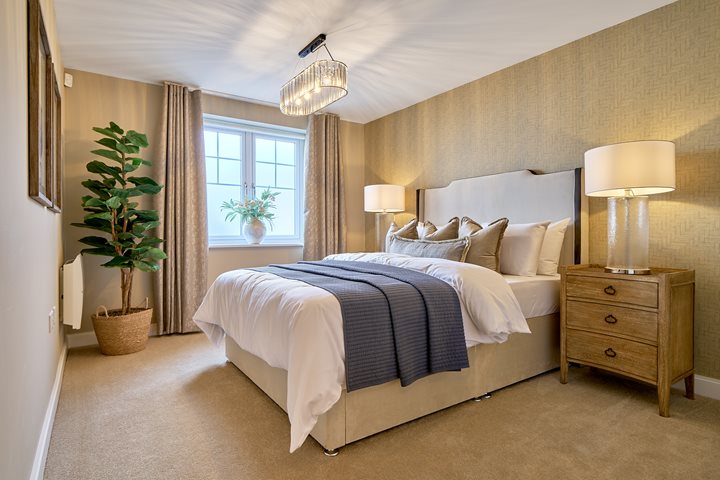 a bedroom with a bed and lamps