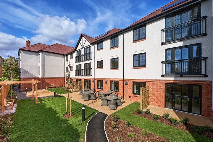 a building with a lawn and a playground in front of it
