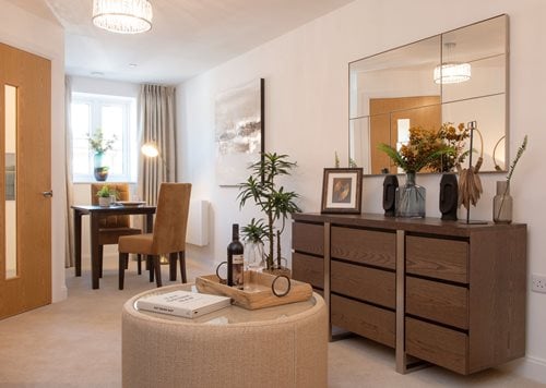 a living room with a table and chairs