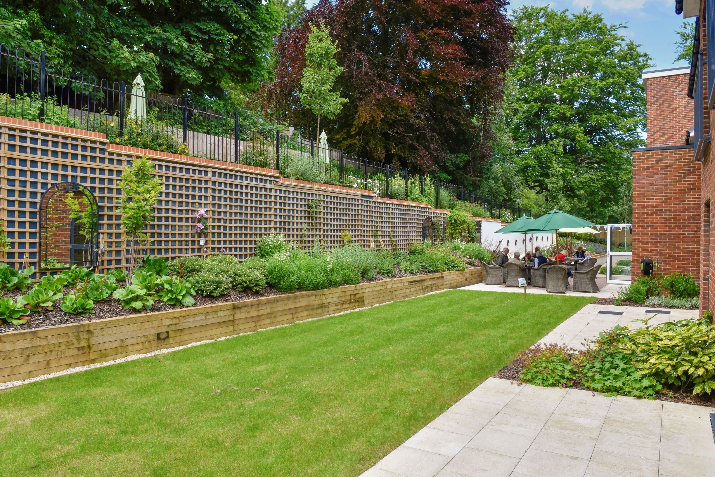 a brick wall with a brick fence and a lawn with a stone wall