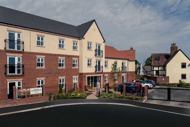 a brick building with a parking lot