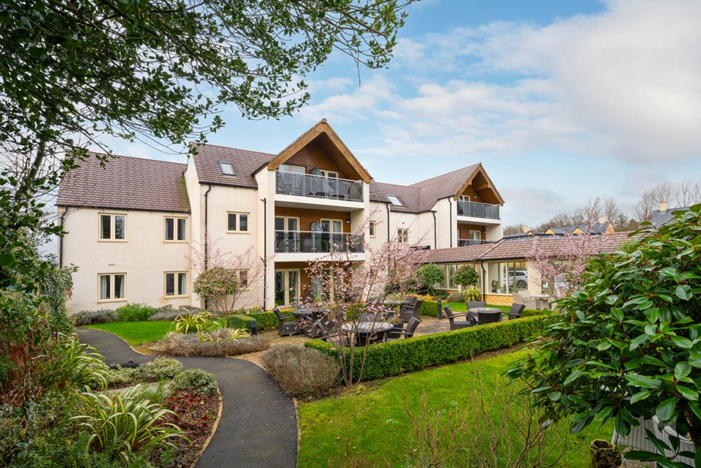a large house with a garden in front of it