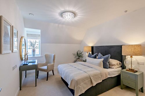 a bedroom with a bed and a chair