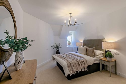 a bedroom with a bed and lamps