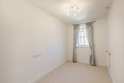 a room with a window and curtains