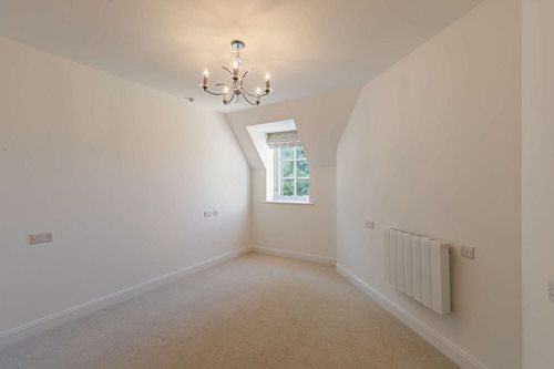 a room with a chandelier and a window