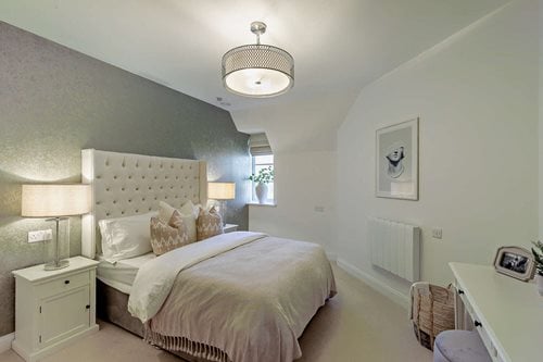 a bedroom with a bed and lamps