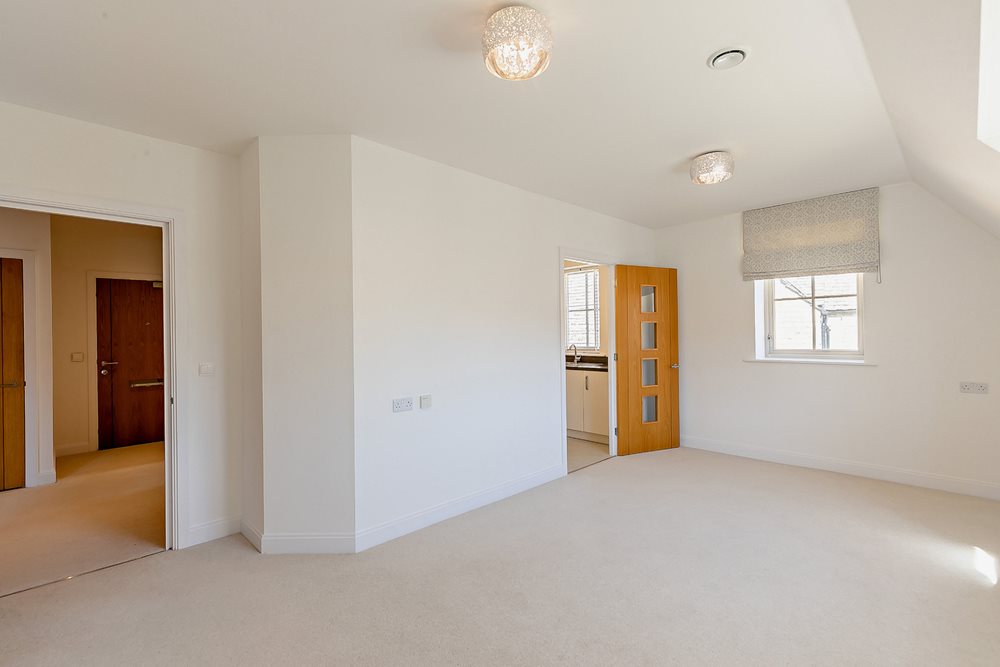 a room with a carpet and a door