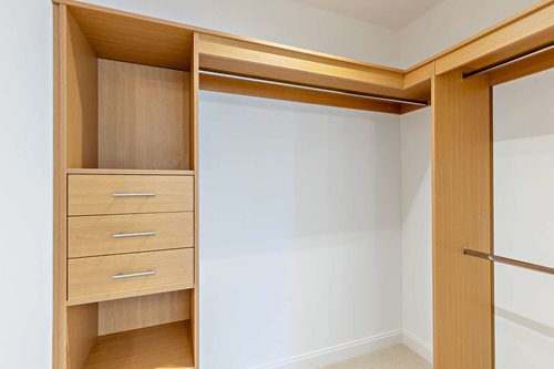 a room with a wood cabinet and a door