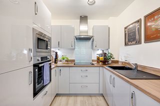 a kitchen with white cabinets